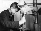 Виктор Петрашов работает на сверлильном станке  1959 год